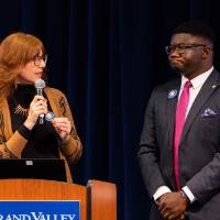 Melissa Baker-Boosamra, associate director for the Office of Student Life, introduces&nbsp;Albert Okwei at podium